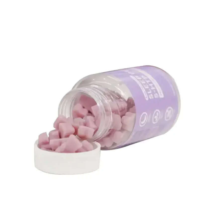 Bottle of grape-flavored sleep gummies designed for restful nights, featuring soft chewable capsules spilling out.